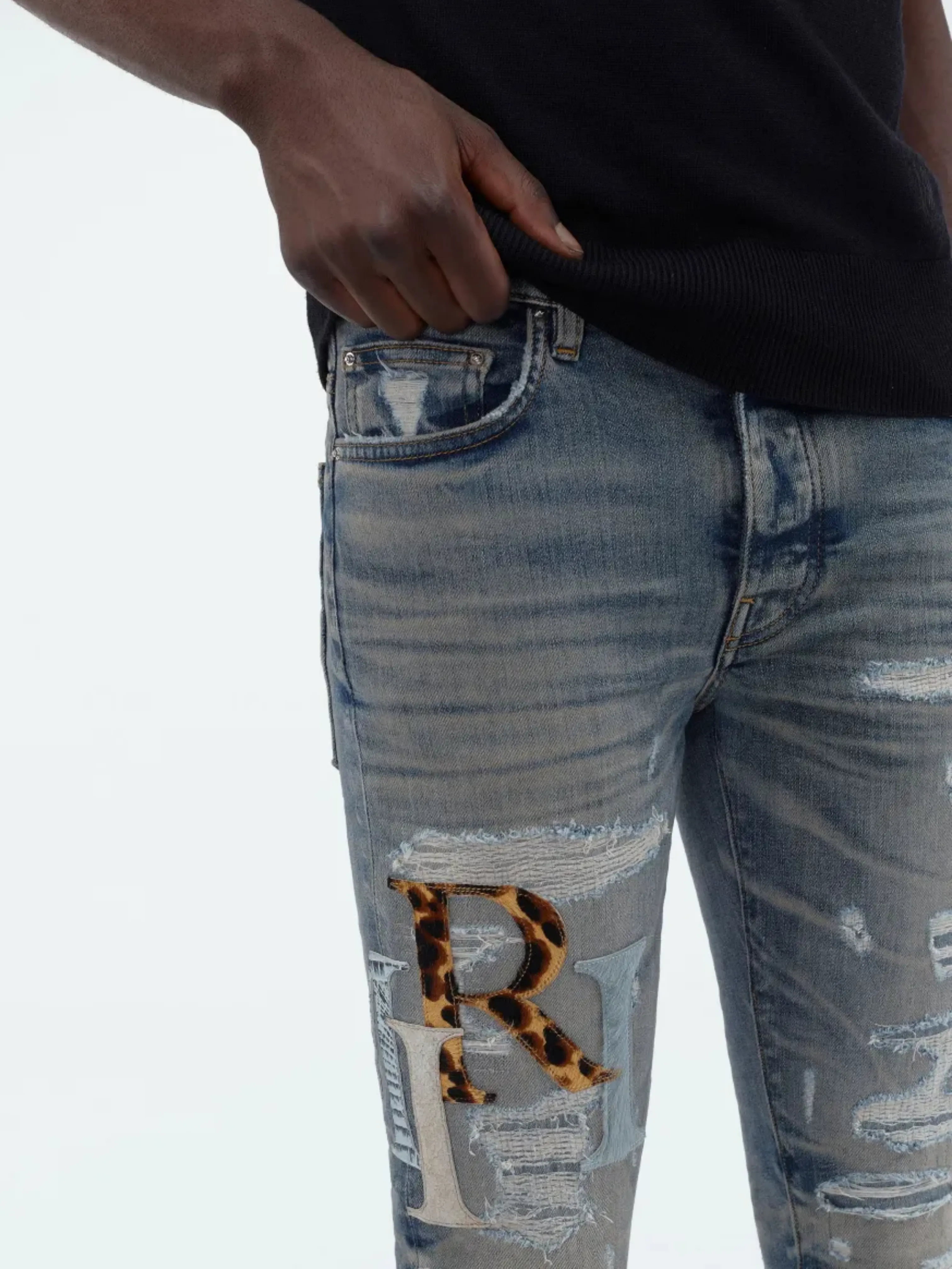 AMIRI STAGGERED LOGO JEANS INDIGO